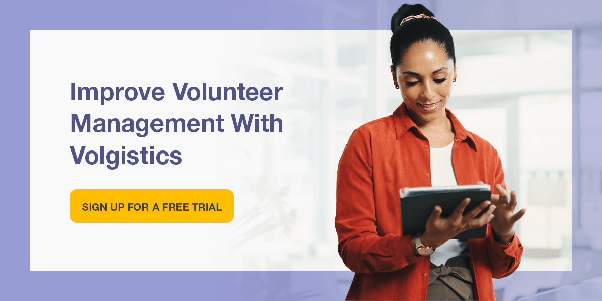 Woman holding tablet managing volunteers. Improve volunteer management with Volgistics.